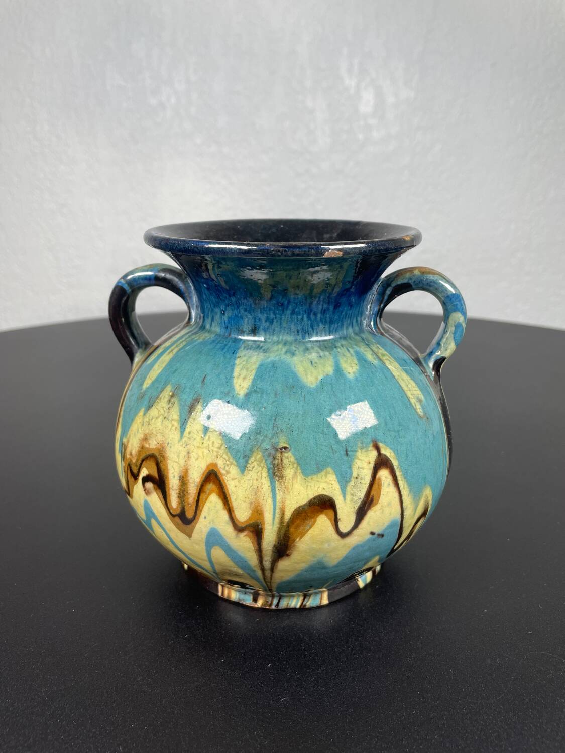 Black ball vase with handle, yellow blue marbled