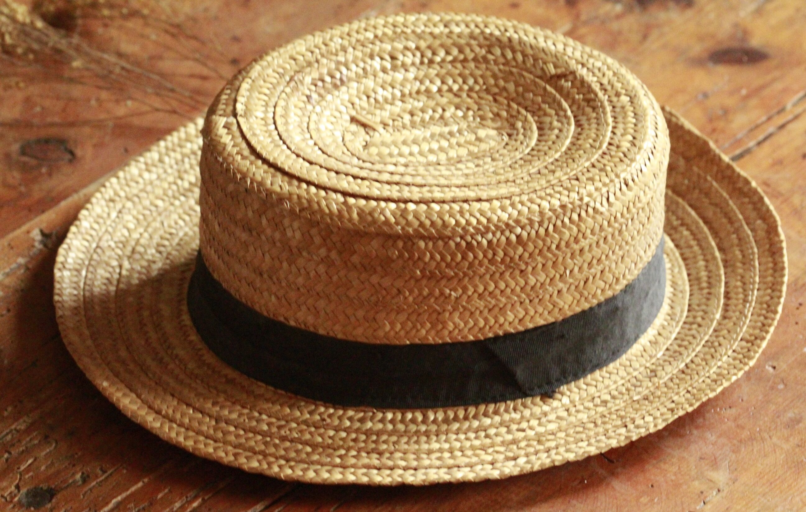 Old straw hat with black ribbon