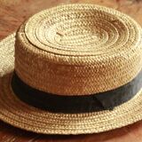 Old straw hat with black ribbon