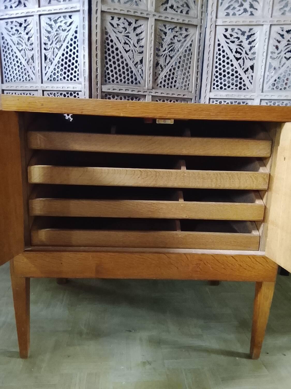 Vintage storage unit with two doors and four drawers.