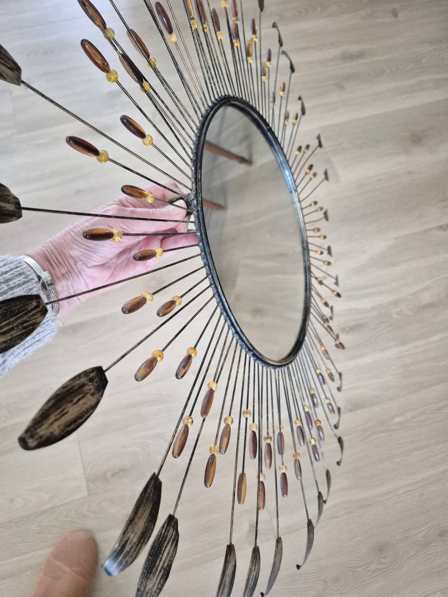 Vintage metal sun mirror in the style of Line Vautrin