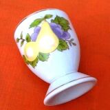 White porcelain egg cup decorated with pears / grapes.
