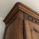 Antique walnut armoire with two doors.