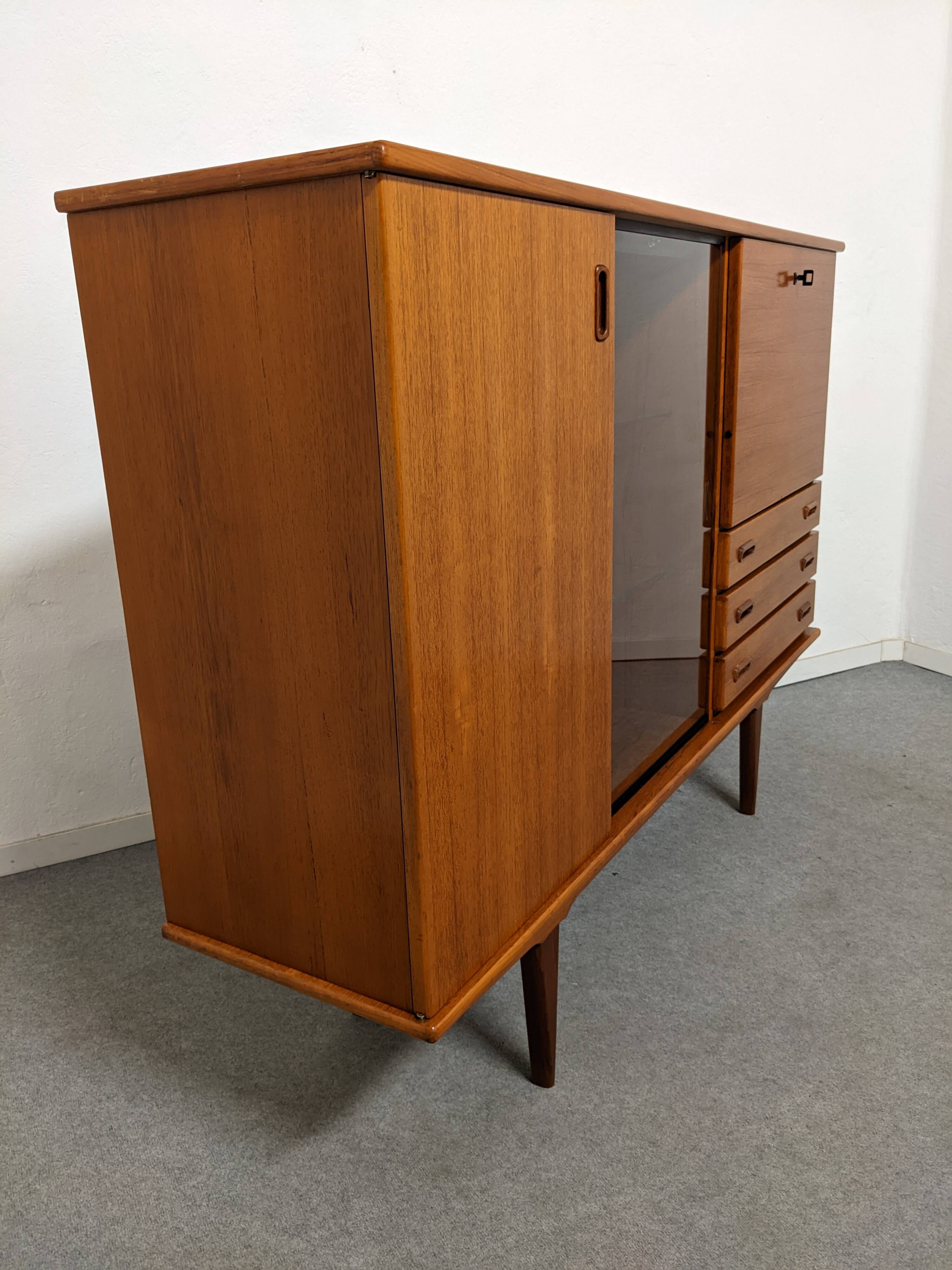 High sideboard, display cabinet and secretary, Scandinavian in teak, France around 1960.
