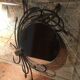 Round mirror surrounded by art deco style metal plants