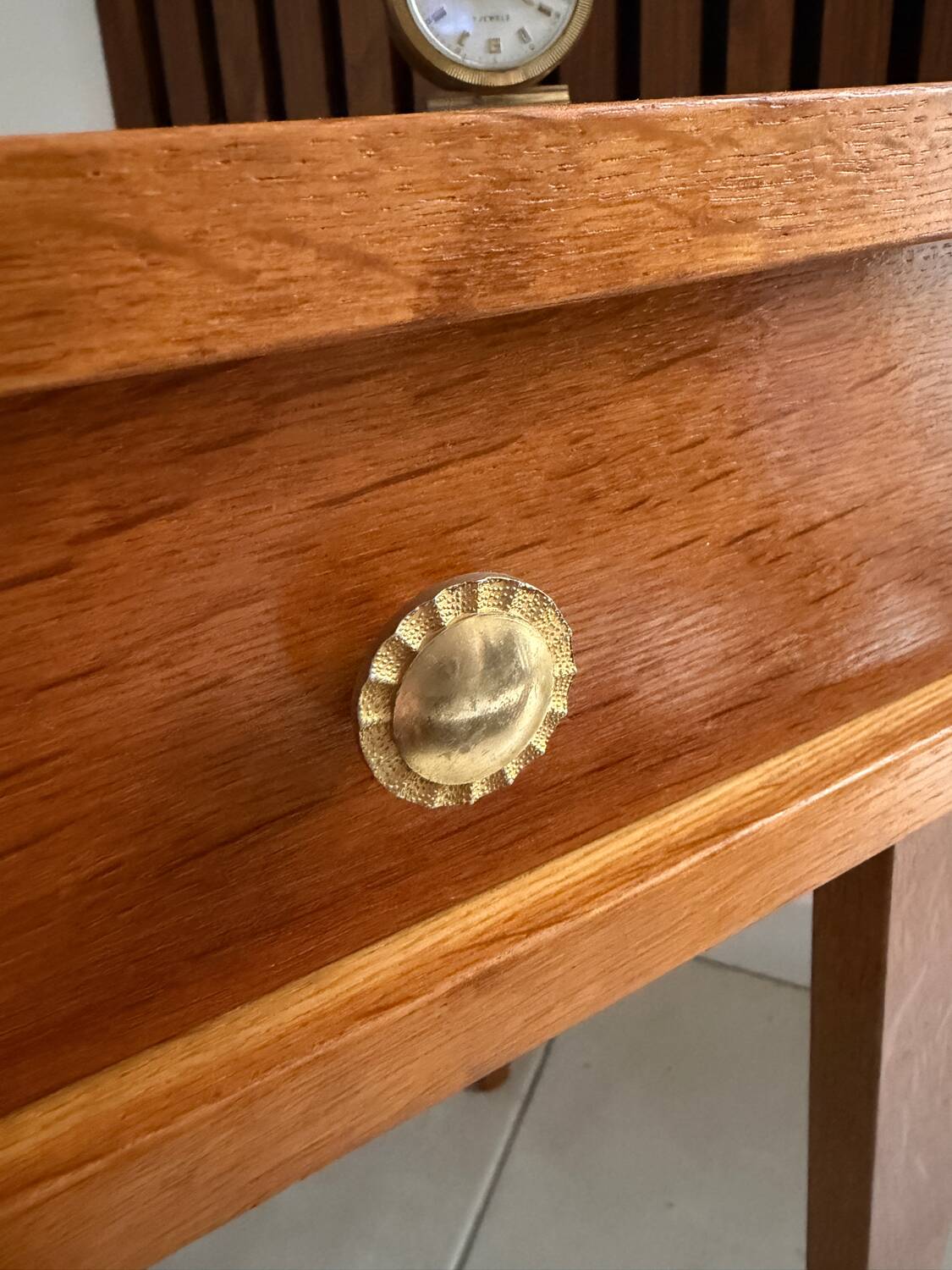 Vintage bedside table with tapered legs.