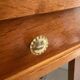 Vintage bedside table with tapered legs.