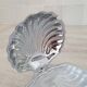 Shell-shaped butter dish in stainless steel and white glass bowl.