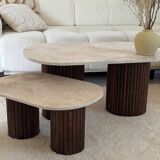 Oval coffee table duo travertine and fluted wooden legs.