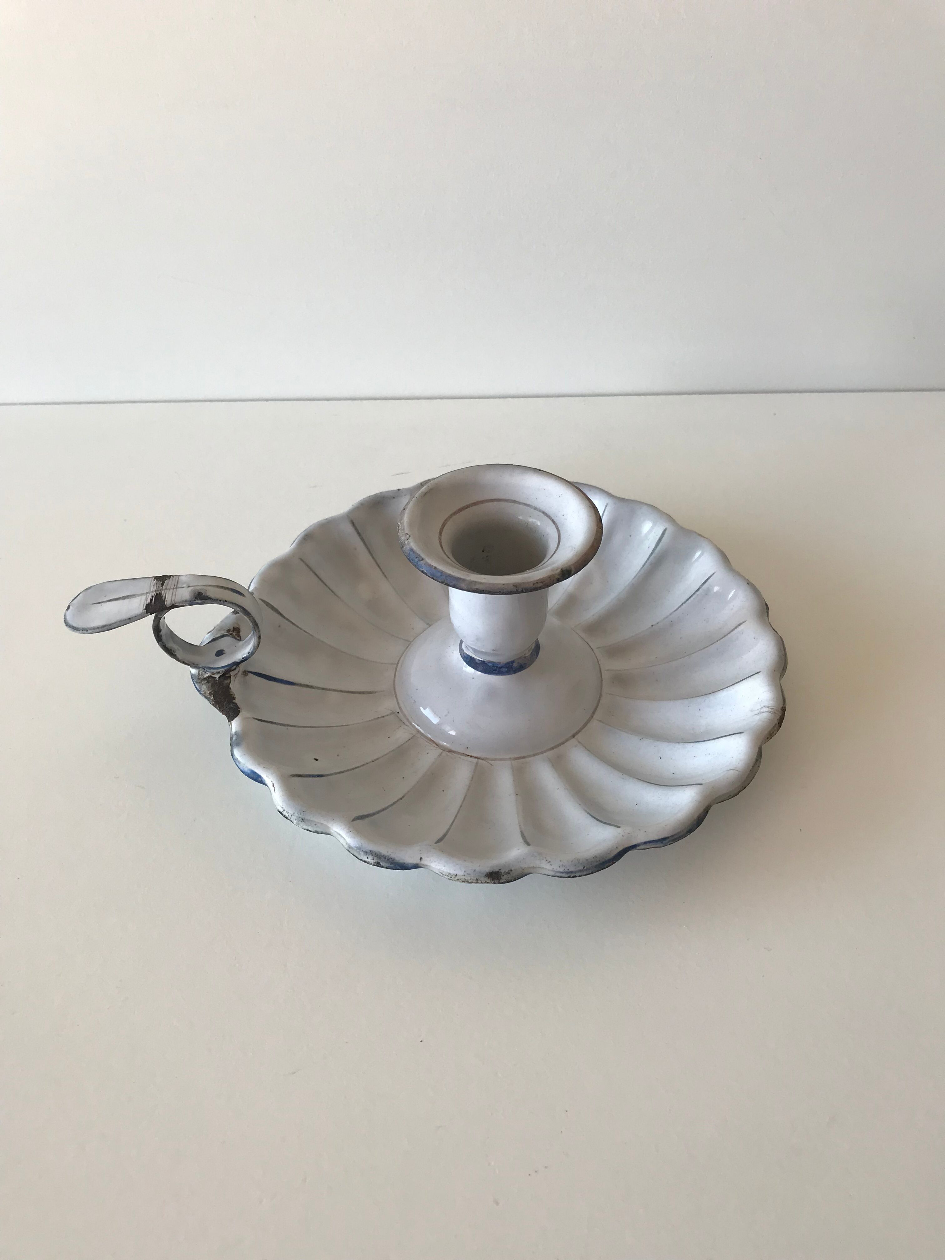 Candlestick in white enameled metal