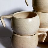 Six vintage potter's ceramic cups with vanilla enamel