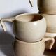 Six vintage potter's ceramic cups with vanilla enamel