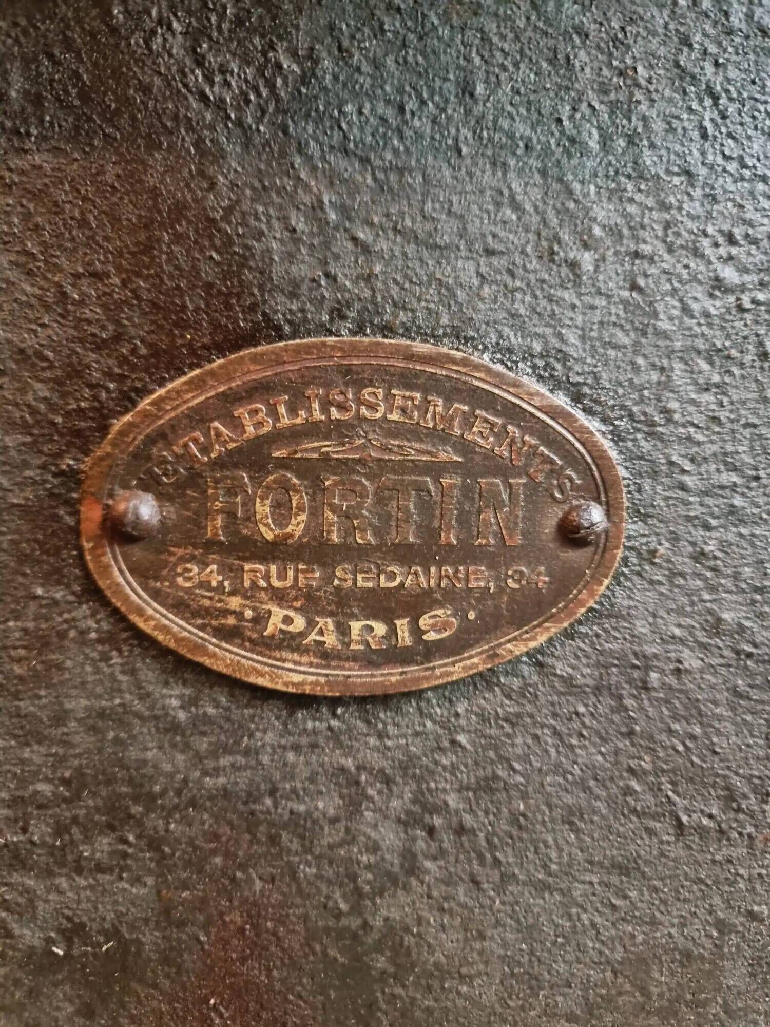 Old French industrial table with a cast iron base and a pine top.
