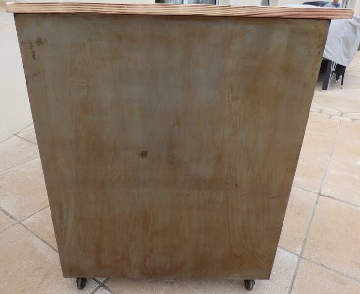 Vintage industrial metal furniture with a rusty effect, featuring two drawers on wheels.