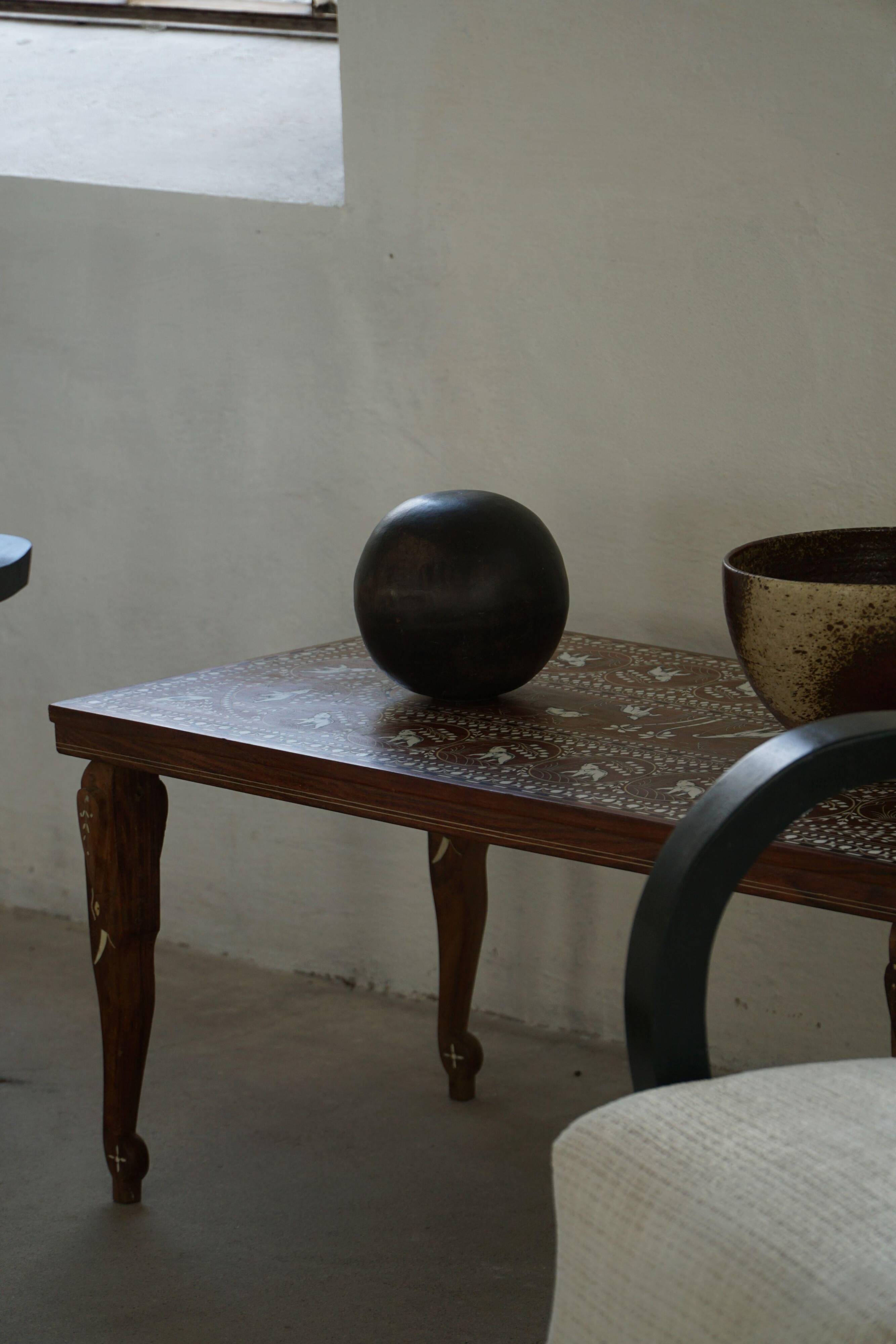 Vintage Indian teak coffee table inlaid with elephant motifs, mid-20th century.