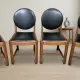 Set of four vintage wooden dining chairs with black leather upholstery, 85 × 45 × 45 cm
