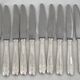 12 dessert, cheese, and hors d'oeuvre knives Grand Prix, Art Deco in silver-plated metal.