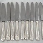 12 dessert, cheese, and hors d'oeuvre knives Grand Prix, Art Deco in silver-plated metal.