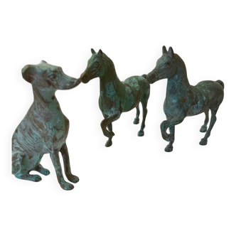 bronze statues of horses and dogs