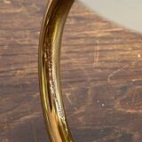 Gold metal wall light with ribbed glass.