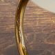 Gold metal wall light with ribbed glass.