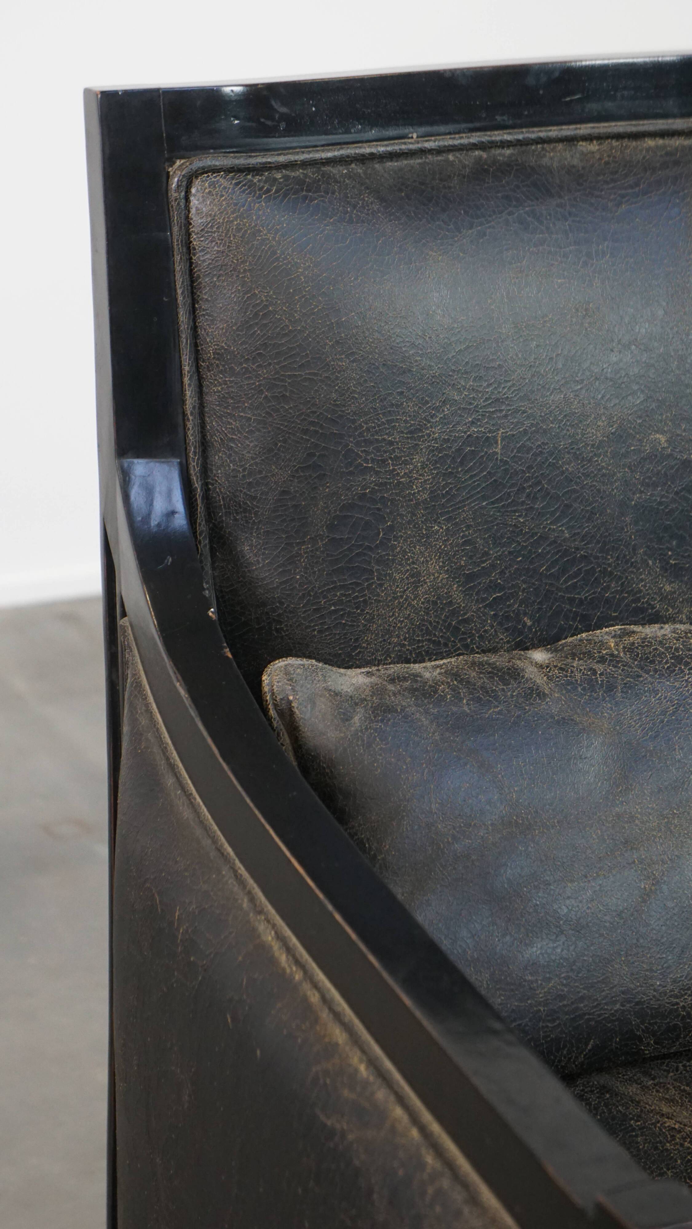 Armchair in black cowhide leather and wood with an Art Deco design