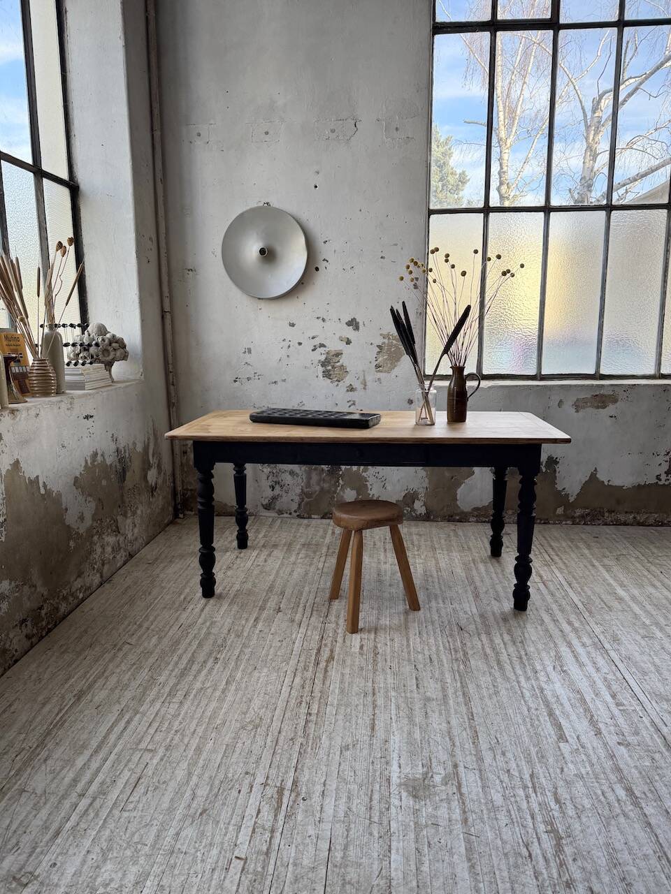 Oak farmhouse table with turned black legs.