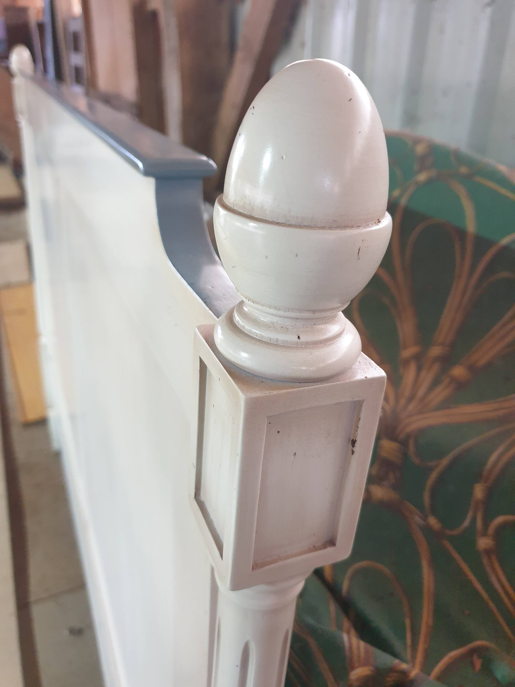 White headboard in Napoleon style with brass feet.