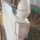 White headboard in Napoleon style with brass feet.