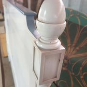 White headboard in Napoleon style with brass feet.