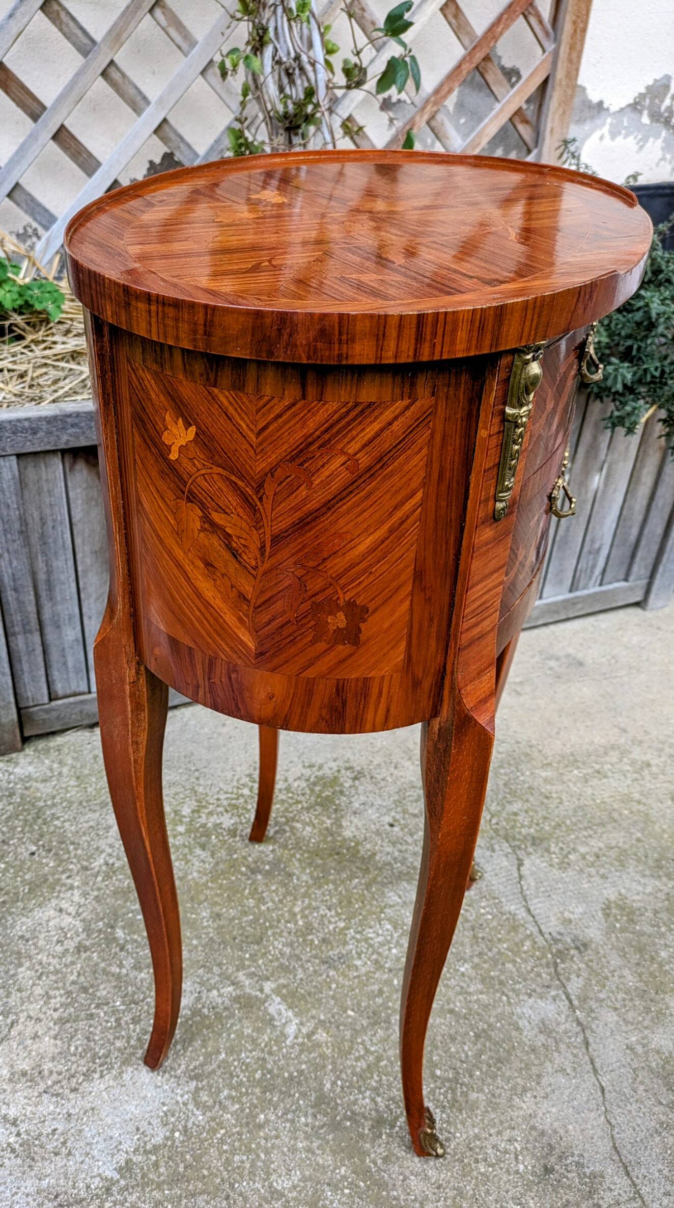 Old oval bedside table in rosewood marquetry Louis XV style