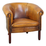 Subtle sheepskin club chair finished with decorative studs