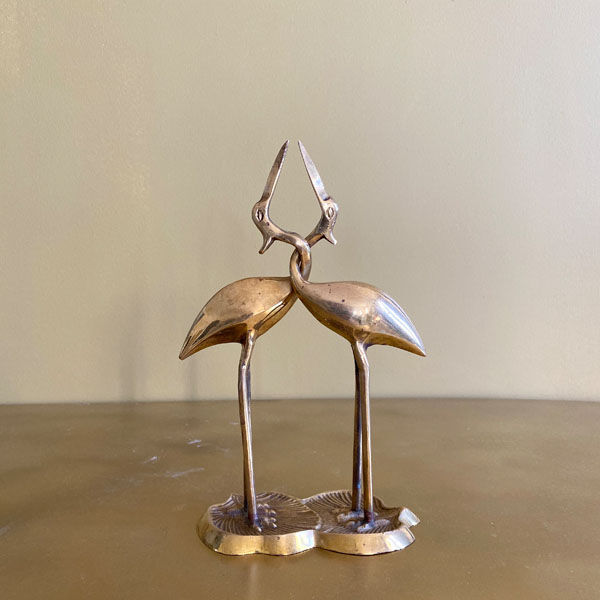 Couple of brass intertwined herons