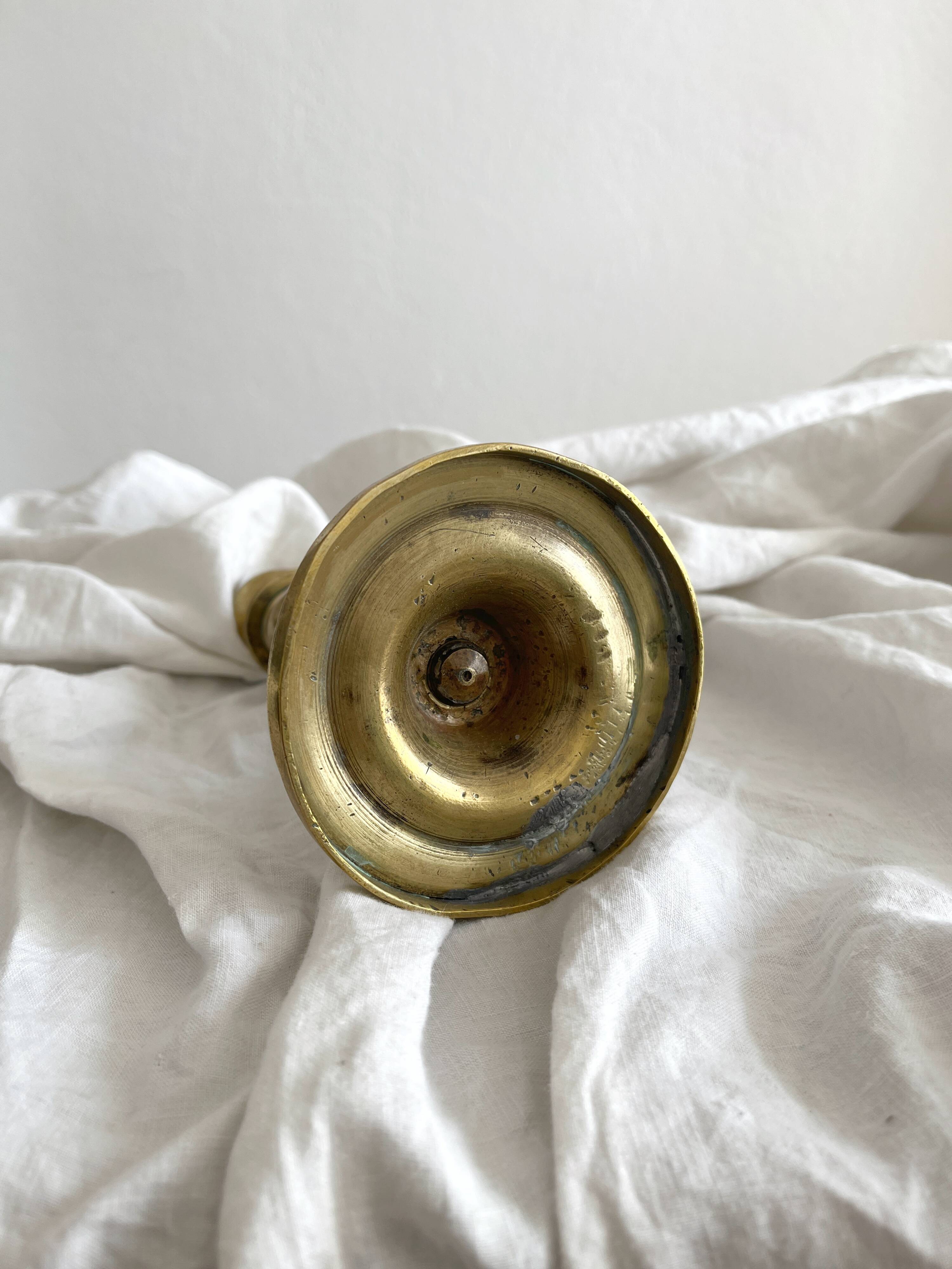 Antique brass candlestick in vintage baluster shape