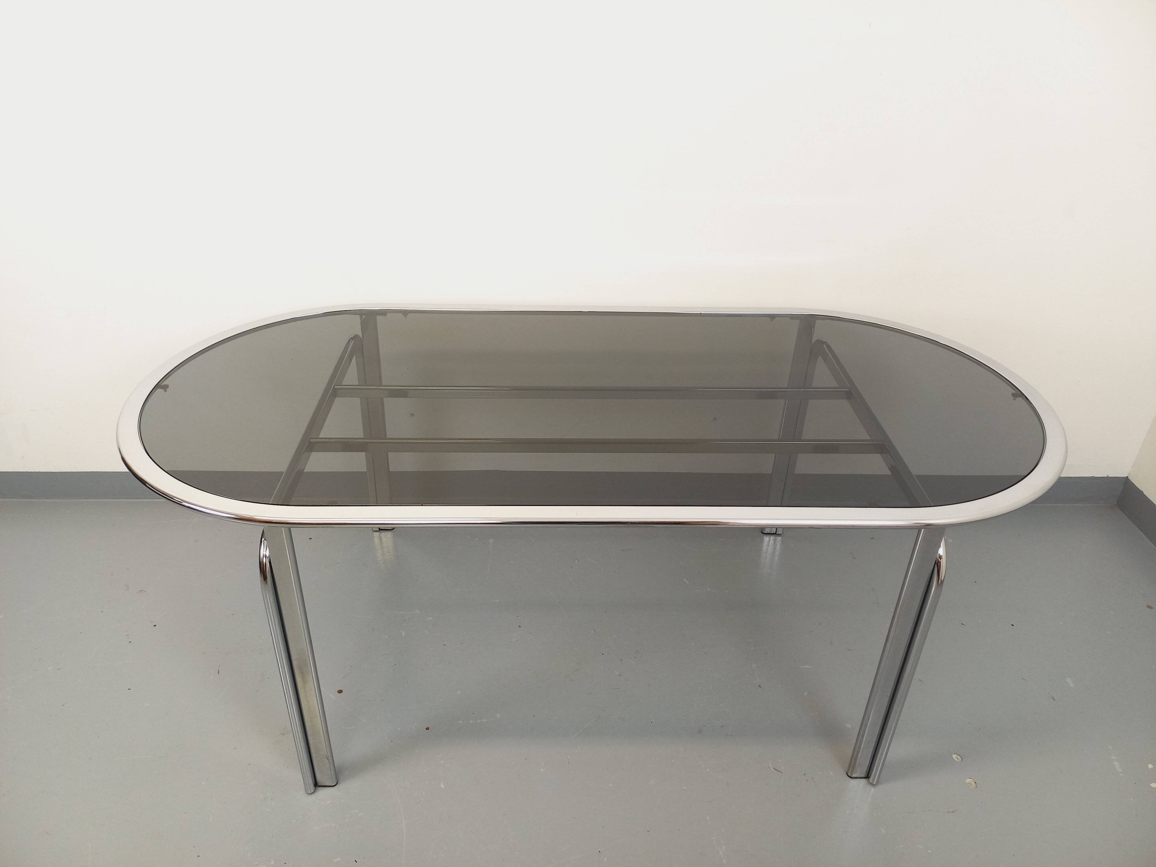Vintage oval dining table in smoked glass and chrome metal, Space Age style.
