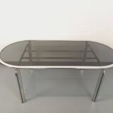 Vintage oval dining table in smoked glass and chrome metal, Space Age style.