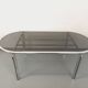 Vintage oval dining table in smoked glass and chrome metal, Space Age style.