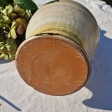 Handcrafted jug or jar with a handle, terracotta pottery vase, fat lava effect, stylized flowers
