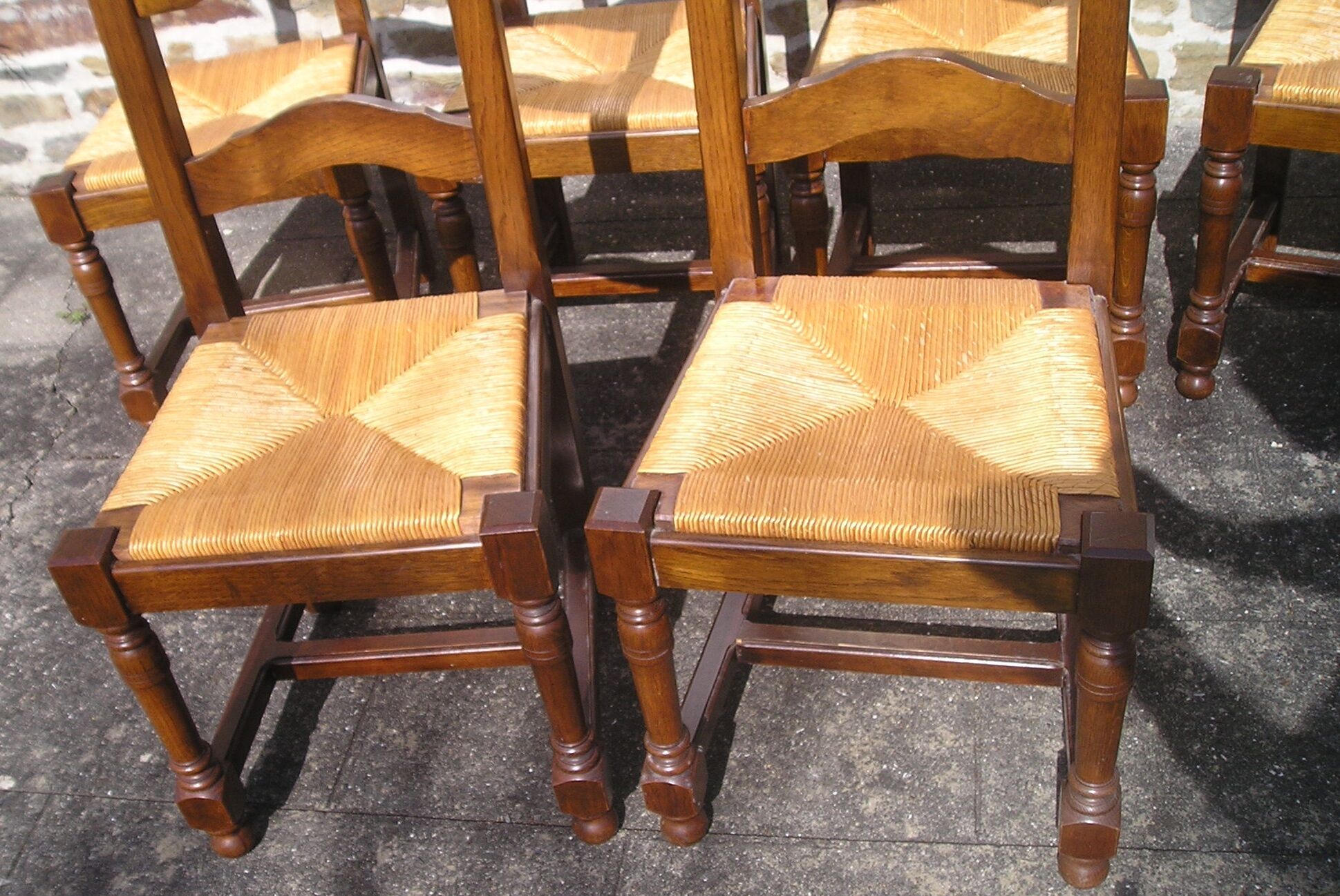Set of 6 oak dining chairs with high backs and straw seats