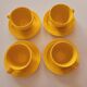 4 yellow cups and saucers