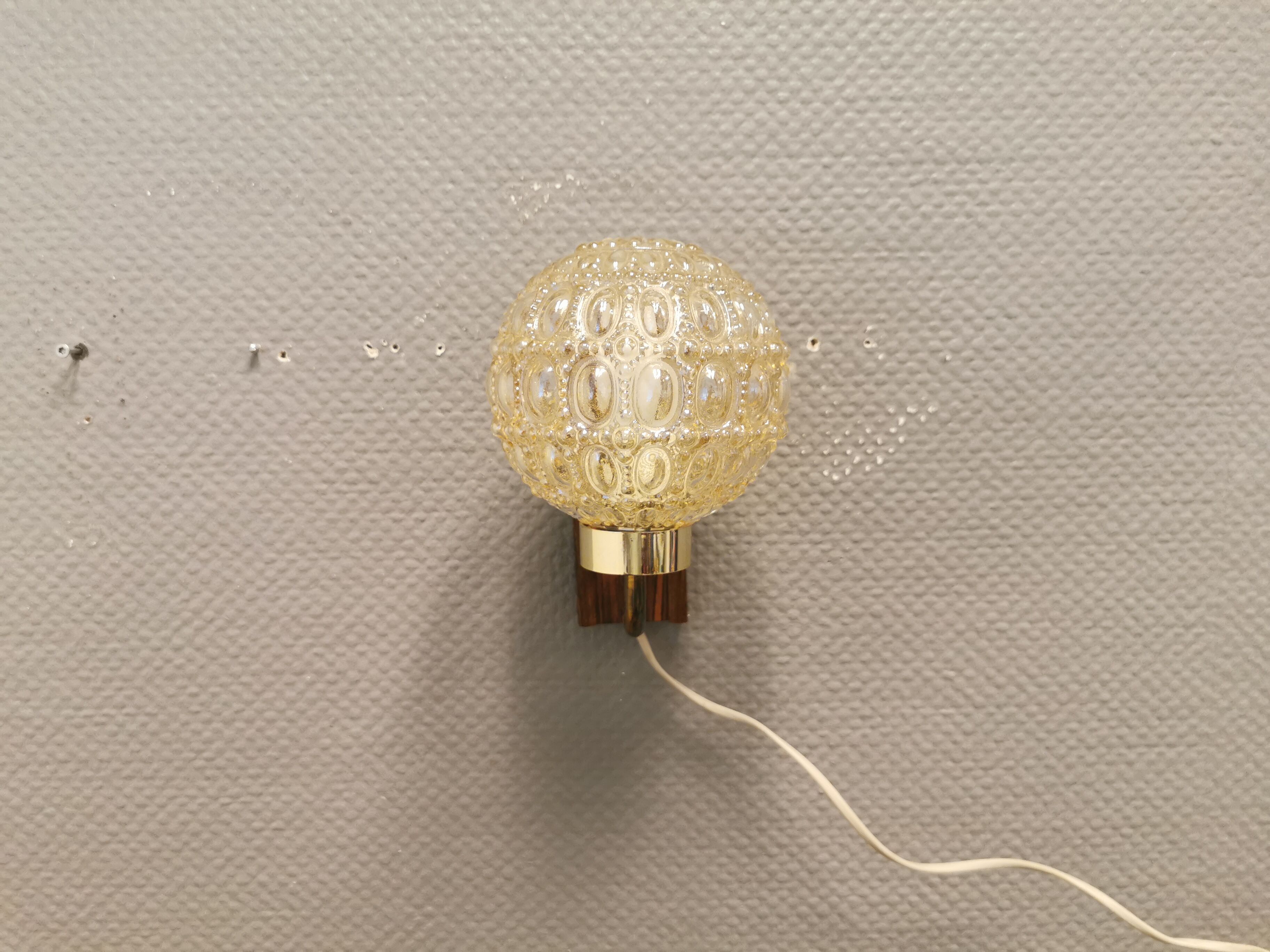 Wall light in rosewood with bobble glass ball shade.