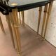 Pull out tables in brass and black glass XX century