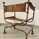 Curule leather armchair