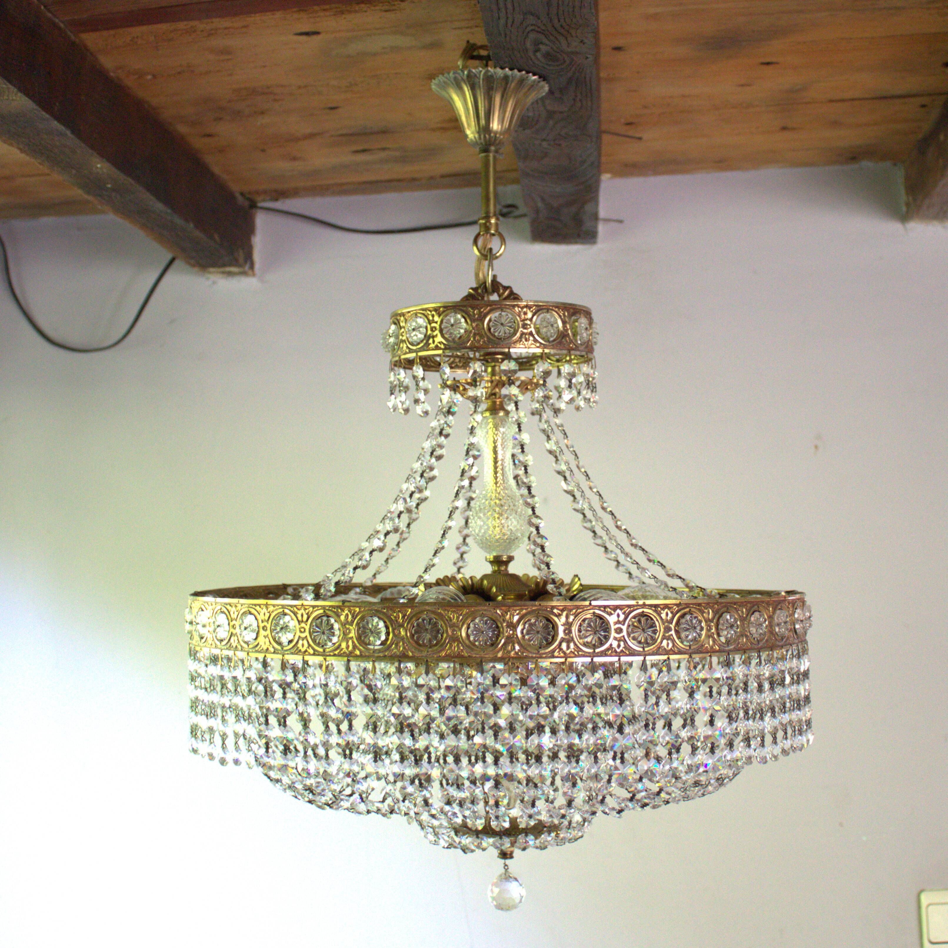 Antique castle style chandelier with tassels and floral details