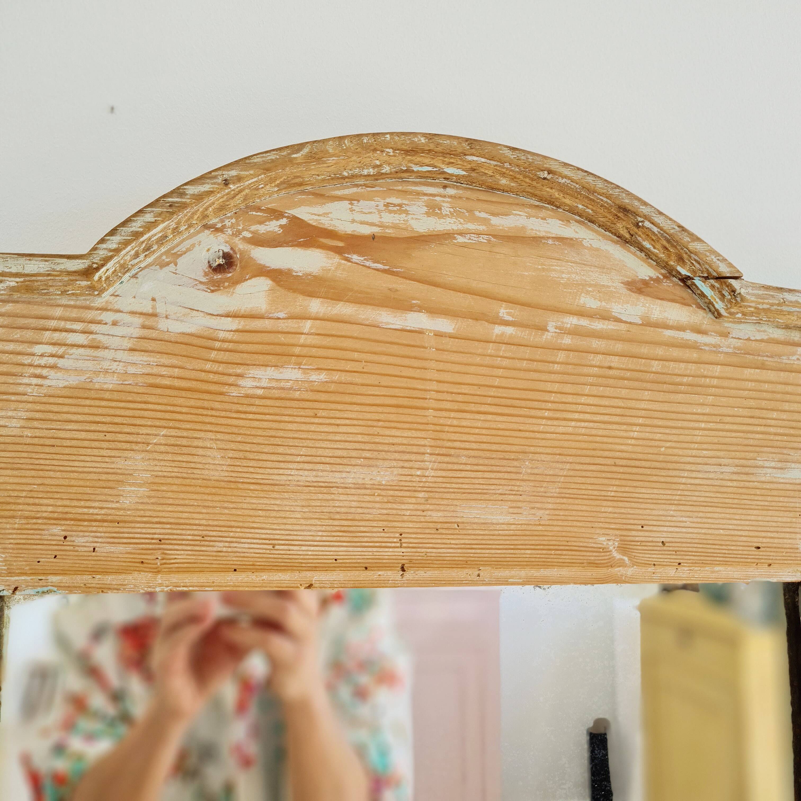 Antique mirror in raw wood with a patina and pediment.