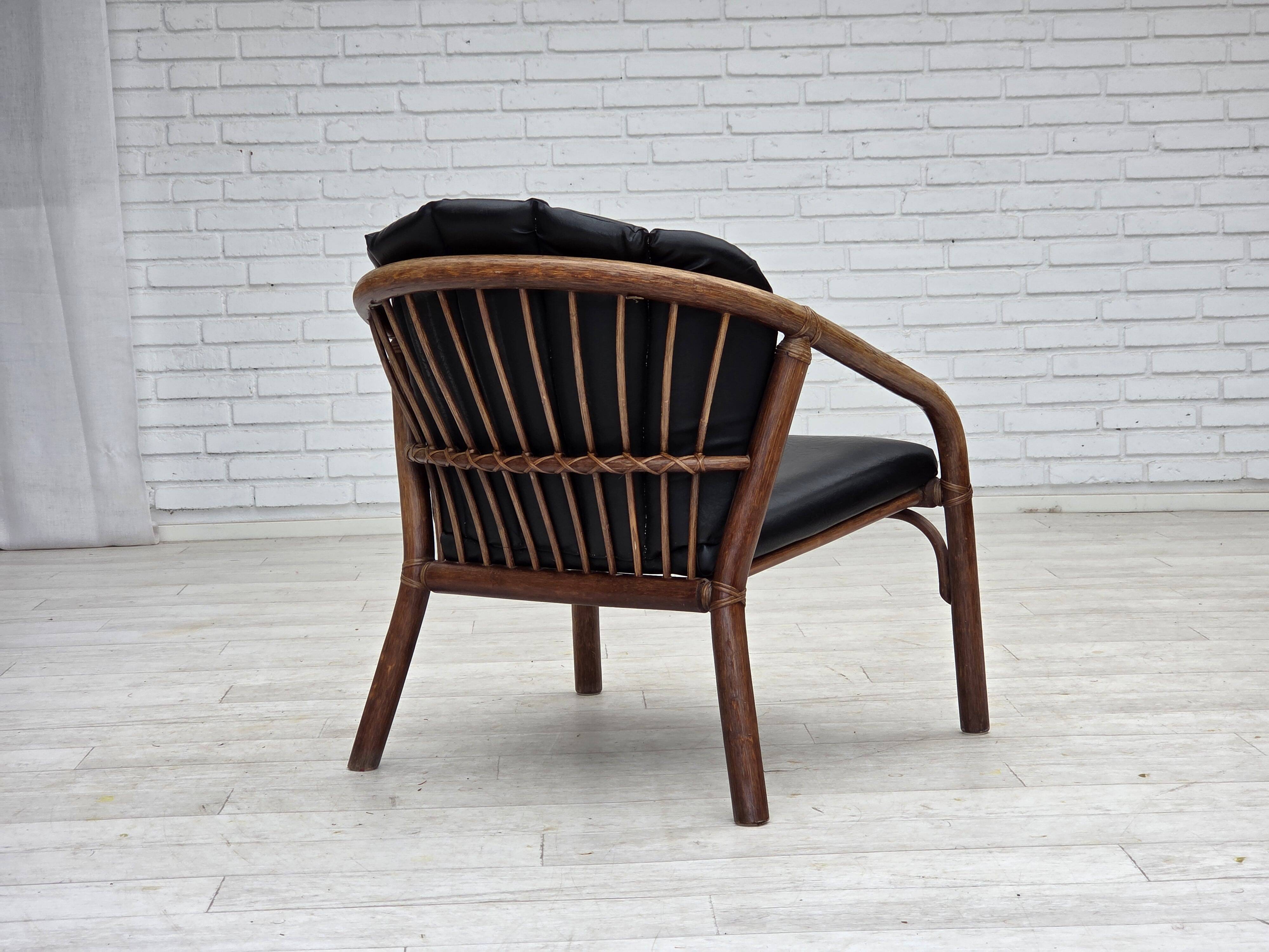 1970s, Danish armchair, rattan, black artificial leather.