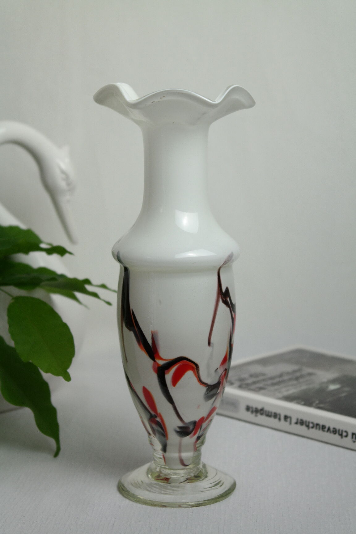 Corolla vase in white opaline with orange-brown patterns.