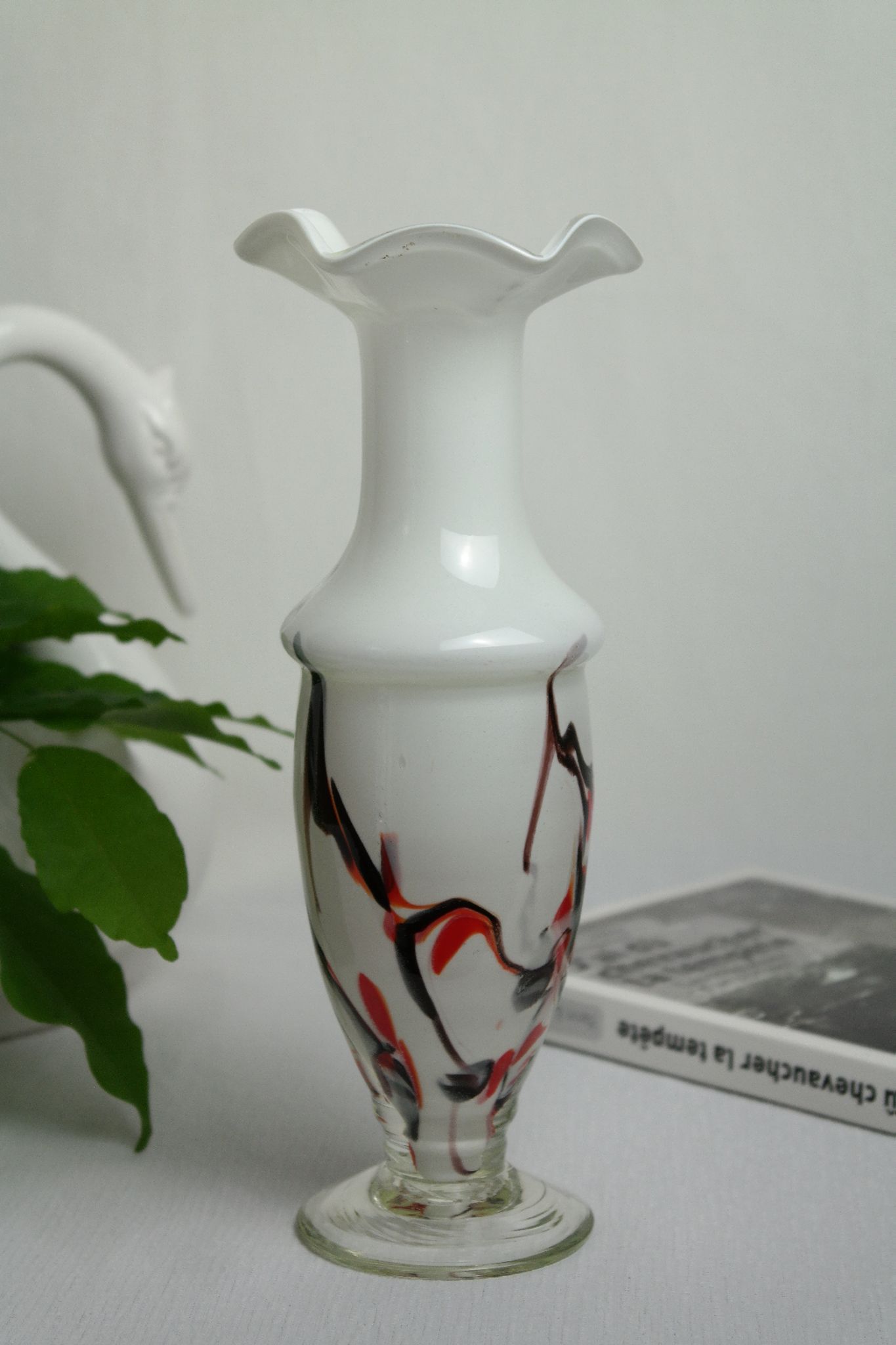 Corolla vase in white opaline with orange-brown patterns.