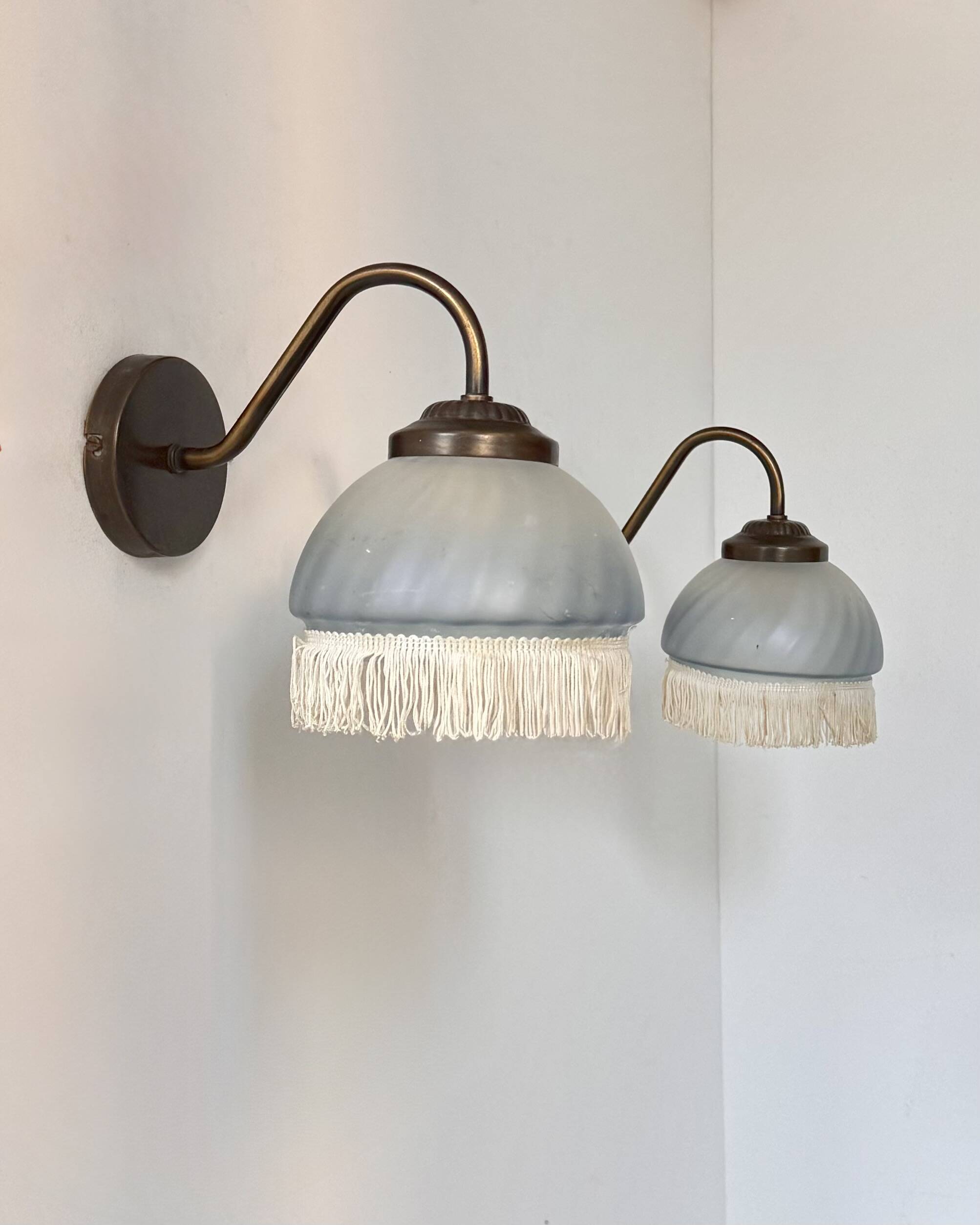 Pair of vintage wall lights in brass and blue-tinted glass, France 1970.