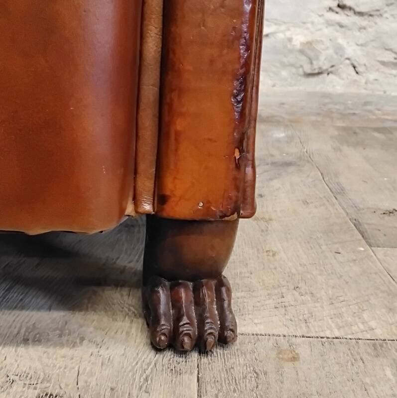 Club chair with moustache back and lion feet.